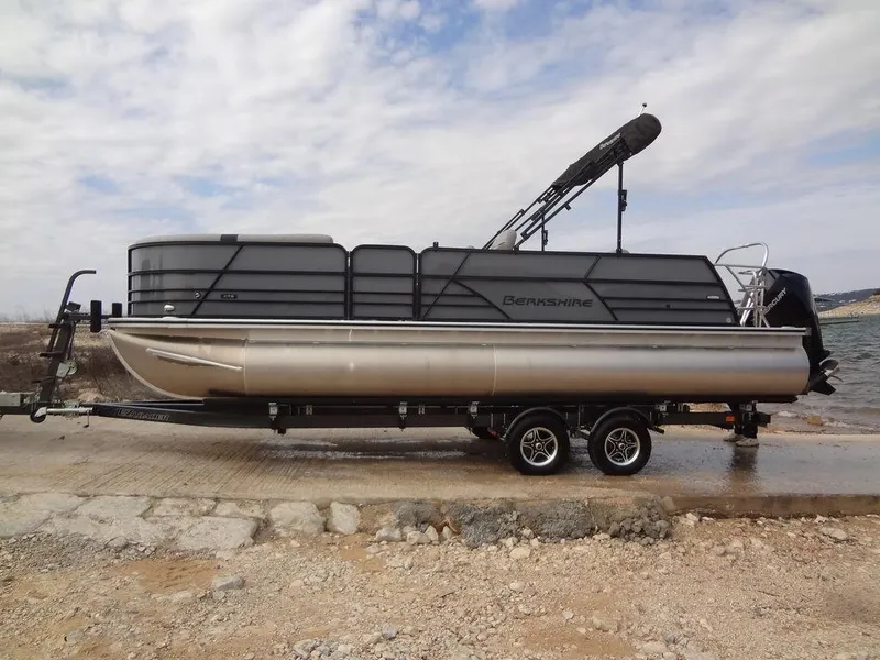 Slide: The Image of 2023 Berkshire 24UL CTS 3.0 pontoon boat on trailer by the water. - 35
