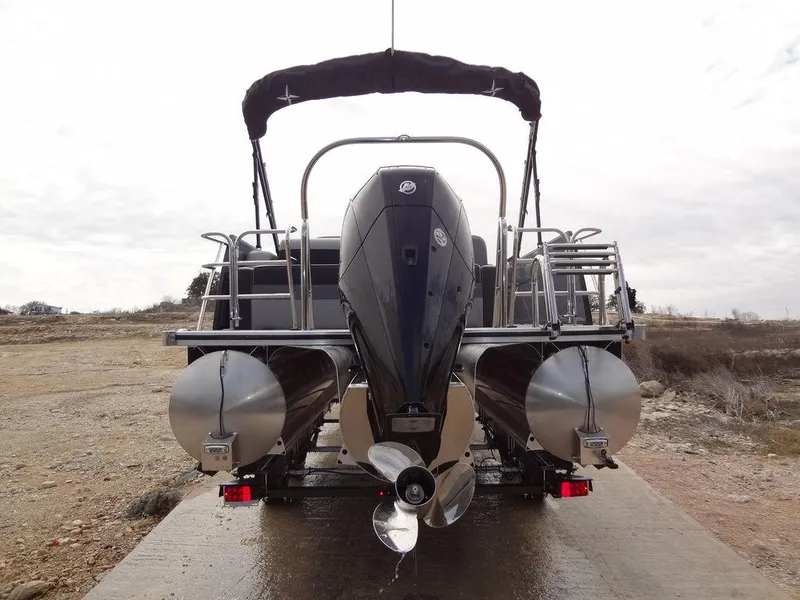 Slide: The Image of 2023 Berkshire 24UL CTS 3.0 pontoon boat, rear view with motor and dual pontoons. - 37
