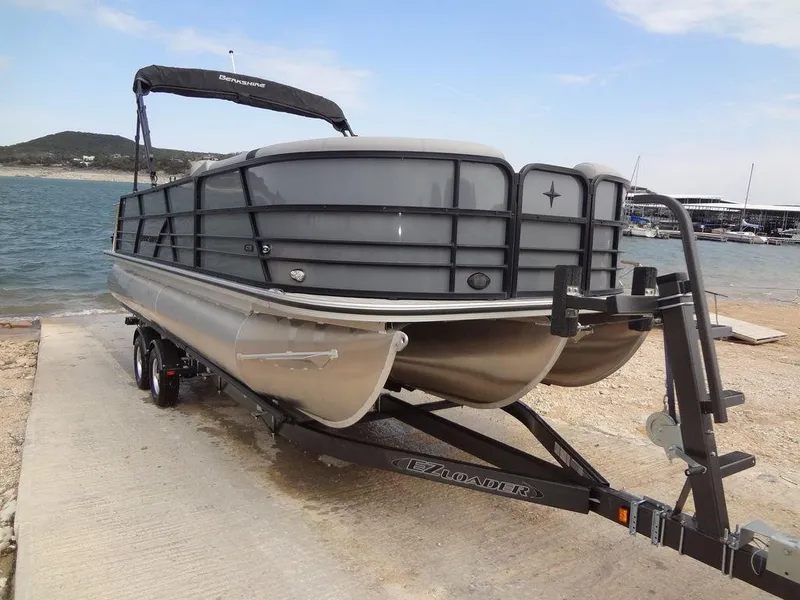 Slide: The Image of 2023 Berkshire 24UL CTS 3.0 pontoon boat on trailer by a lakeside. - 39