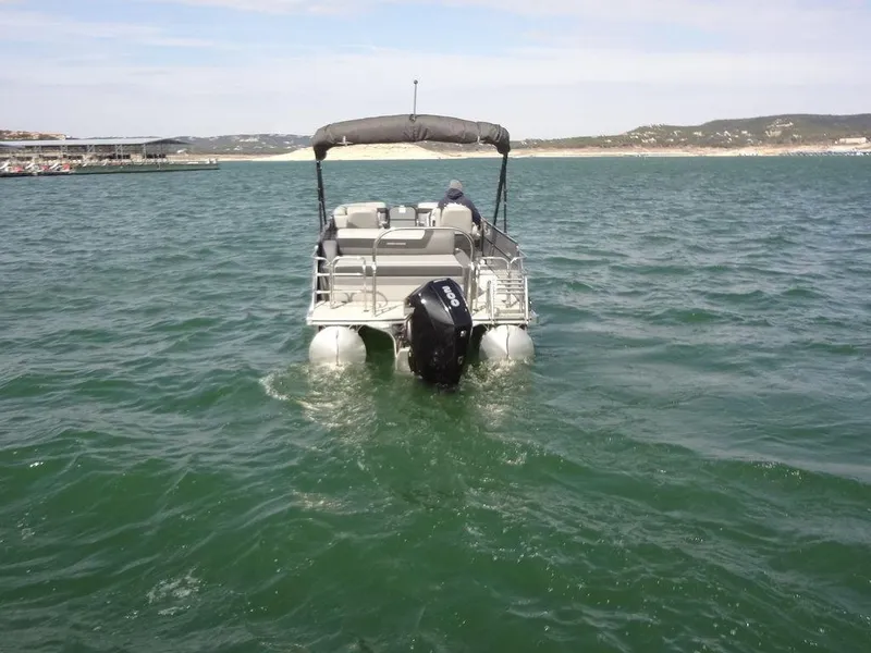 Slide: The Image of 2023 Berkshire 24UL CTS 3.0 pontoon boat on open water, rear view. - 8