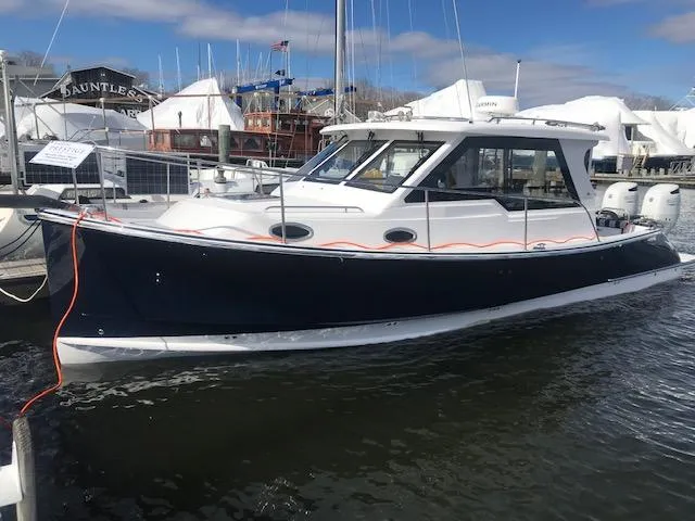 Slide: The Image of 2023 True North 34 Outboard Express boat docked in marina. - 2