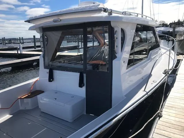 Slide: The Image of 2023 True North 34 Outboard Express docked at a marina. - 3