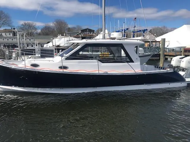 Slide: The Image of 2023 True North 34 Outboard Express boat docked in a marina. - 5