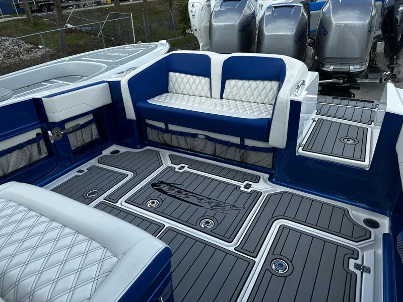 Slide: The Image of 2017 Nor-Tech 390 Center Console boat interior with blue and white seating and deck. - 11