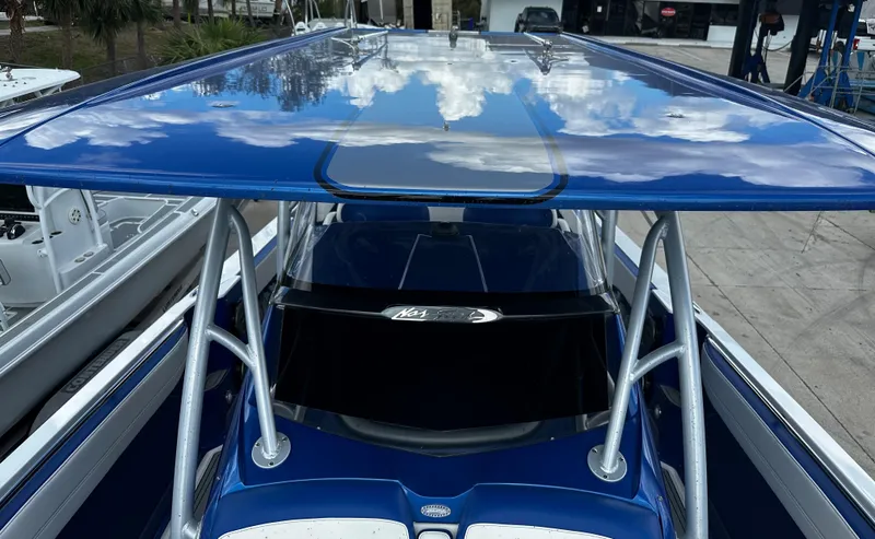 Slide: The Image of 2017 Nor-Tech 390 Center Console boat with blue canopy and sleek design. - 15