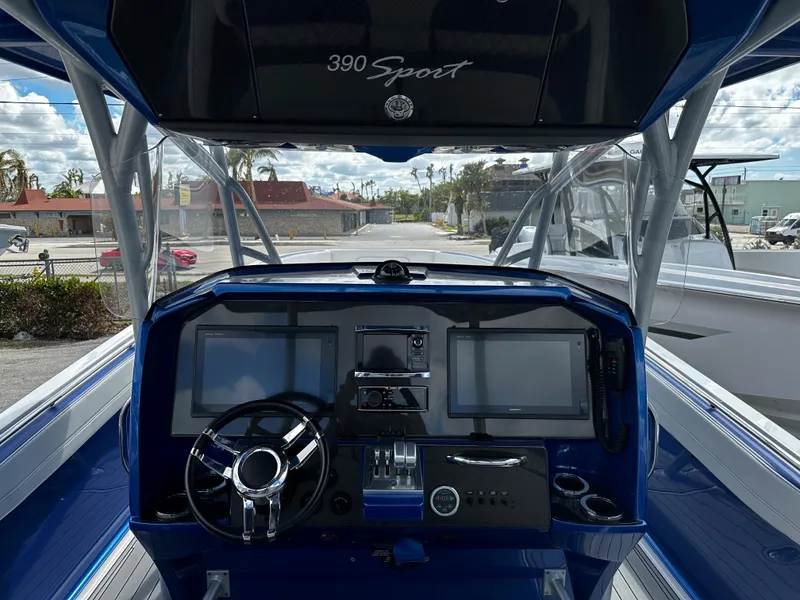 Slide: The Image of 2017 Nor-Tech 390 Center Console boat dashboard with modern controls and dual screens. - 17