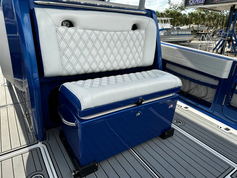 Slide: The Image of 2017 Nor-Tech 390 Center Console with blue and white seating, diamond stitching, and sleek design. - 22