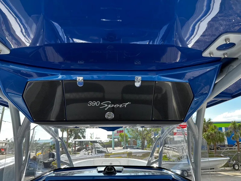 Slide: The Image of 2017 Nor-Tech 390 Center Console boat with blue canopy and "390 Sport" branding. - 24