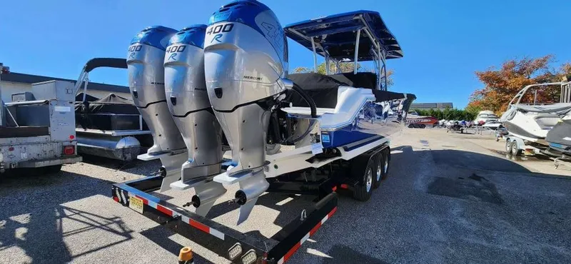 Slide: The Image of 2017 Nor-Tech 390 Center Console boat with triple outboard engines on a trailer. - 4