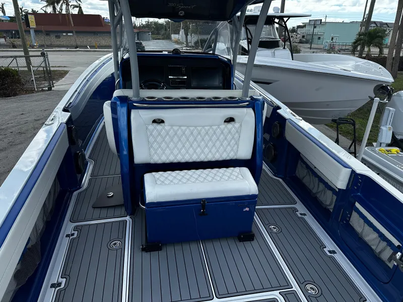 Slide: The Image of 2017 Nor-Tech 390 Center Console boat with blue and white seating, docked outdoors. - 7
