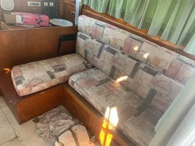 Slide: The Image of 1975 Chris-Craft 30 Tournament FB interior with patterned cushions and wooden cabinetry. - 11