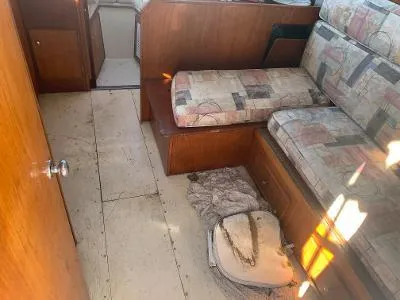 Slide: The Image of Interior of a 1975 Chris-Craft 30 Tournament FB boat with seating and wooden cabinetry. - 13