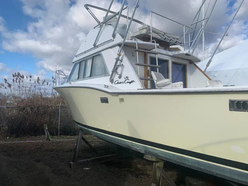 Slide: The Image of 1975 Chris-Craft 30 Tournament FB boat on dry dock under cloudy sky. - 5