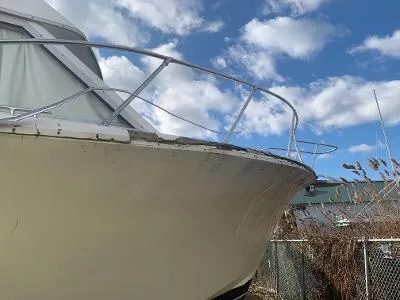 Slide: The Image of 1975 Chris-Craft 30 Tournament FB boat bow under a partly cloudy sky. - 7