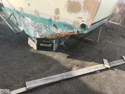 Slide: The Image of 1975 Chris-Craft 30 Tournament FB boat undergoing restoration, showing hull damage. - 8