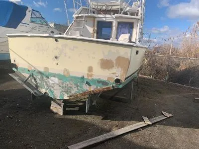 Slide: The Image of 1975 Chris-Craft 30 Tournament FB boat in need of restoration, docked on land. - 9