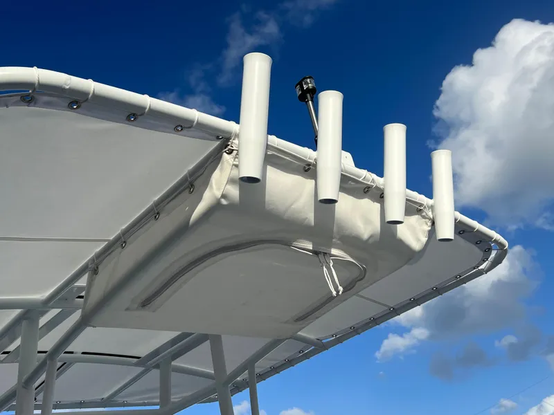 Slide: The Image of Piranha B2200 CASADOR 2023 boat canopy with rod holders against blue sky. - 12