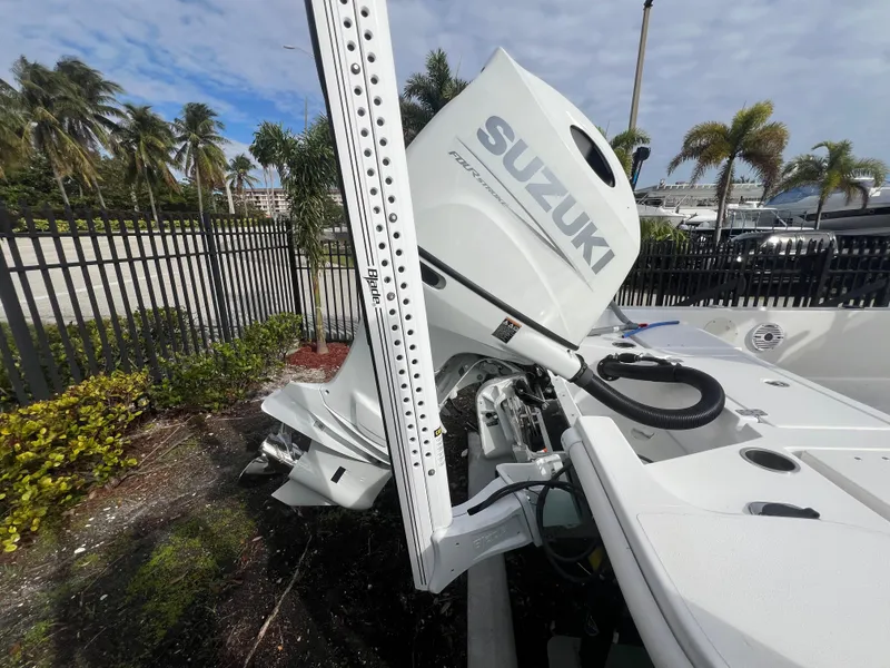 Slide: The Image of Piranha B2200 CASADOR 2023 with Suzuki outboard motor, palm trees in background. - 31