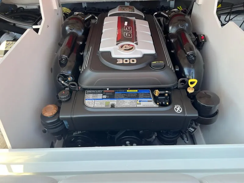 Slide: The Image of 2023 Crownline 240 SS boat engine compartment with a powerful 6.2L 300 HP engine. - 6