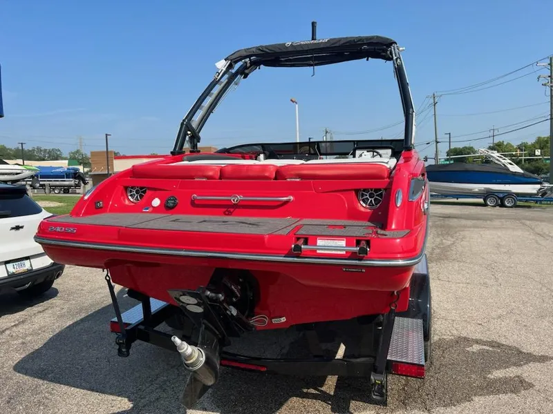 Slide: The Image of 2023 Crownline 240 SS boat in red, rear view on trailer. - 7