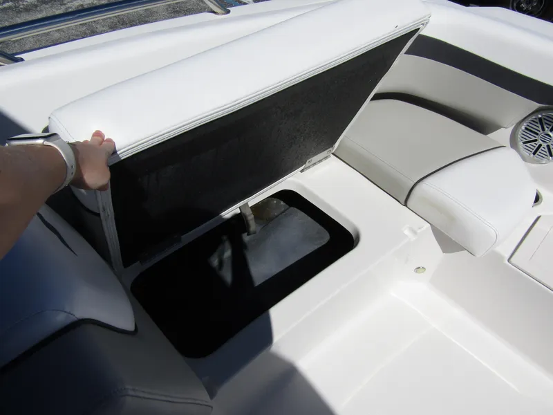 Slide: The Image of 2023 Starcraft SVX 190 OB boat with open storage compartment and white seating. - 12