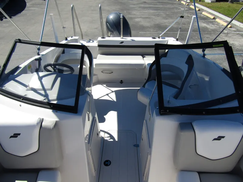 Slide: The Image of 2023 Starcraft SVX 190 OB boat interior with dual consoles and seating. - 15