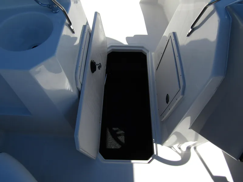 Slide: The Image of 2023 Starcraft SVX 190 OB boat storage compartment with open hatch and sink. - 18