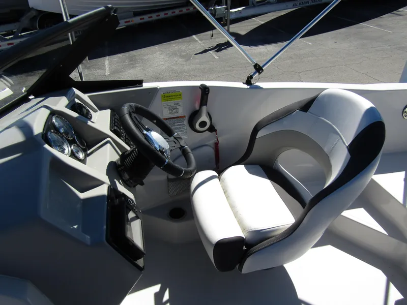Slide: The Image of 2023 Starcraft SVX 190 OB boat cockpit with steering wheel and comfortable seating. - 26