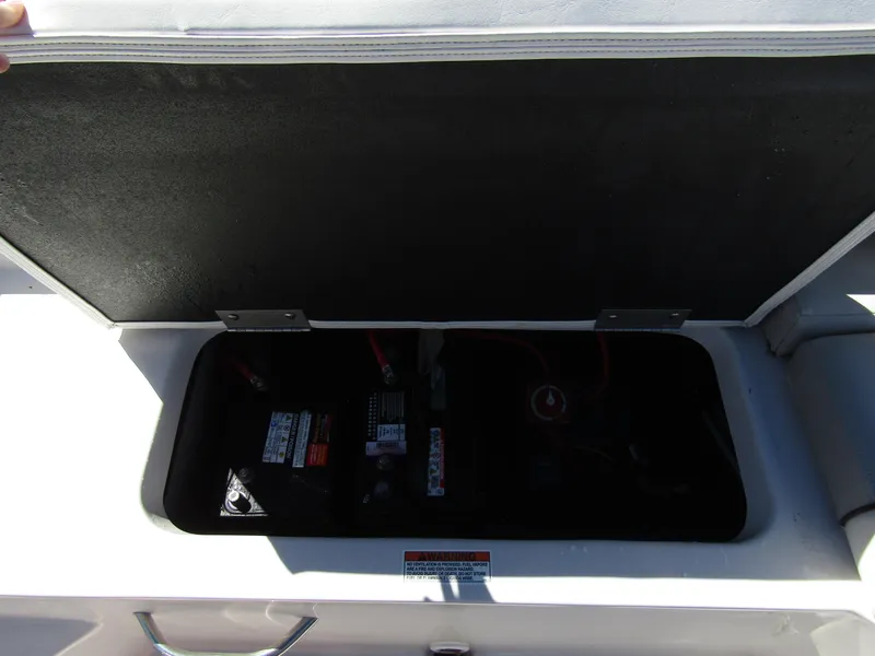 Slide: The Image of 2023 Starcraft SVX 190 OB boat battery compartment with open lid. - 30
