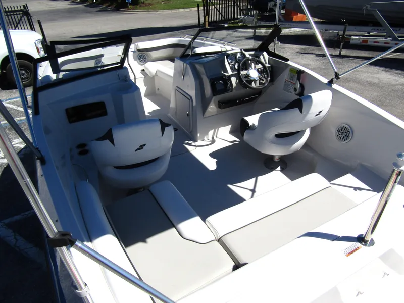 Slide: The Image of 2023 Starcraft SVX 190 OB boat interior with white seating and modern dashboard. - 37