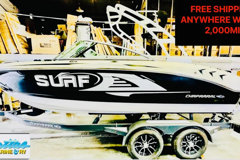 Slide: The Image of New 2023 Chaparral 21 Surf boat on trailer, priced at $72,900. - 0