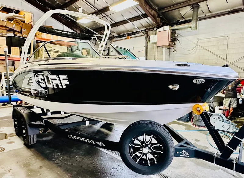 Slide: The Image of 2023 Chaparral 21 Surf boat interior with white and black seating. - 10