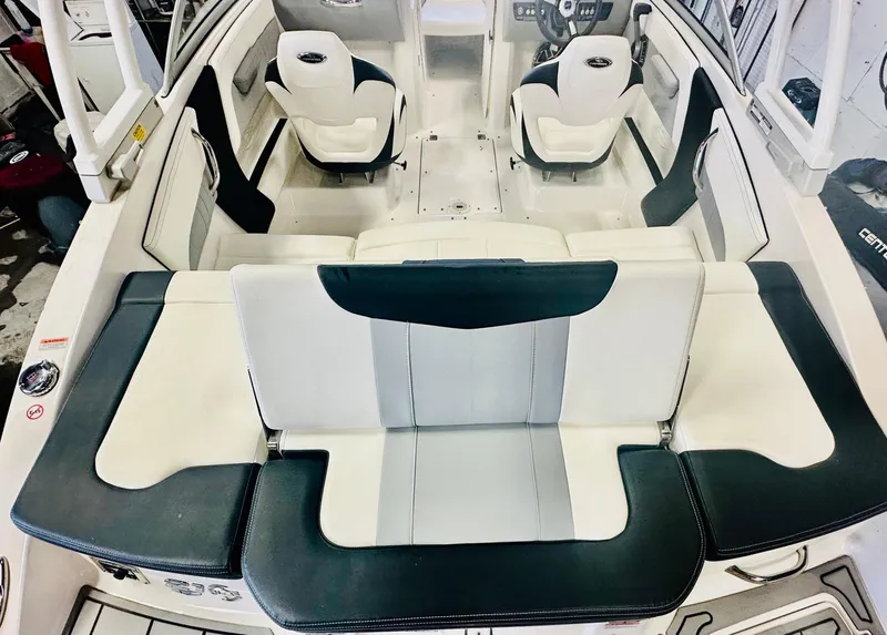 Slide: The Image of 2023 Chaparral 21 Surf boat interior with white seating and built-in speakers. - 15