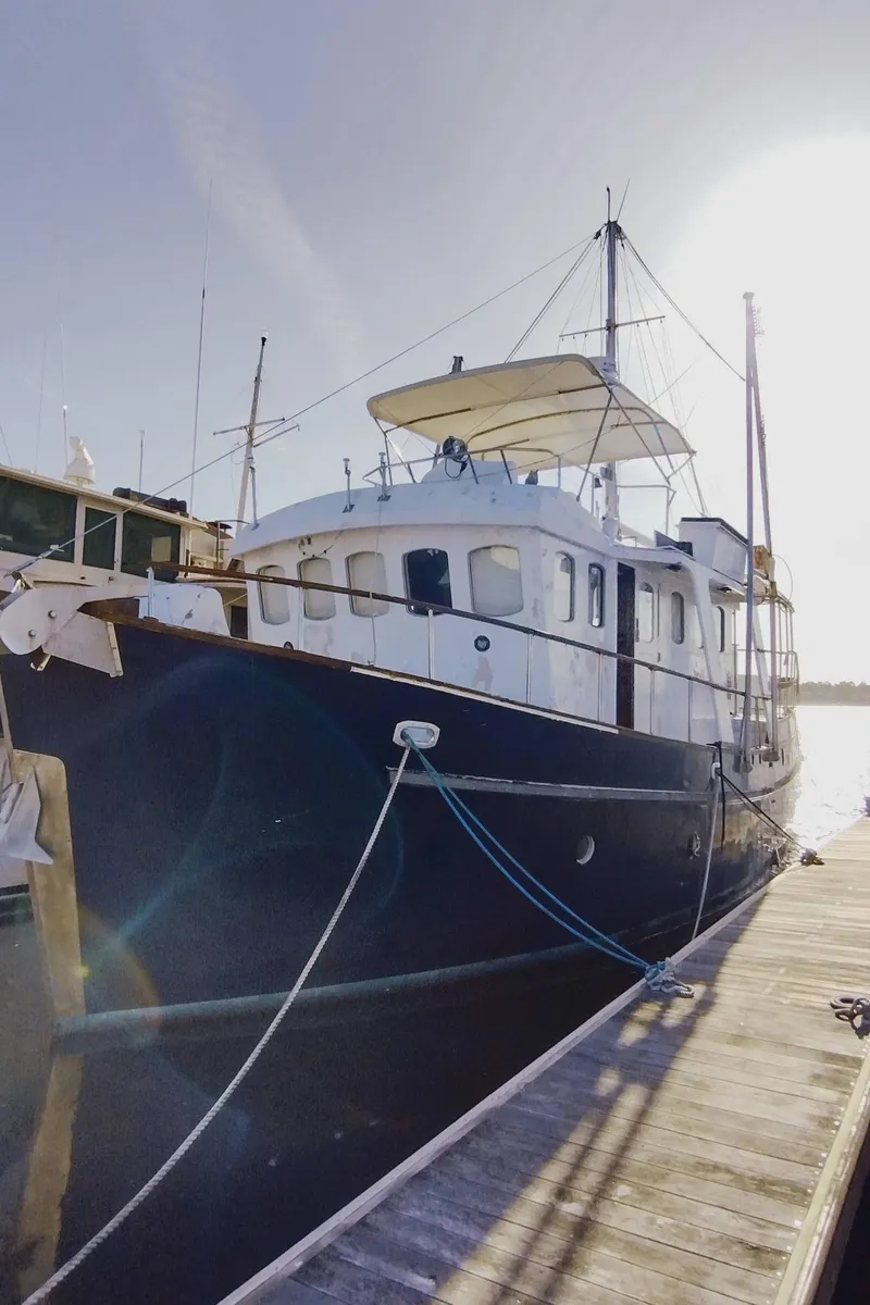 The Image of 1983 Cygnus Custom Trawler docked, showcasing classic nautical design and sturdy build. - 1