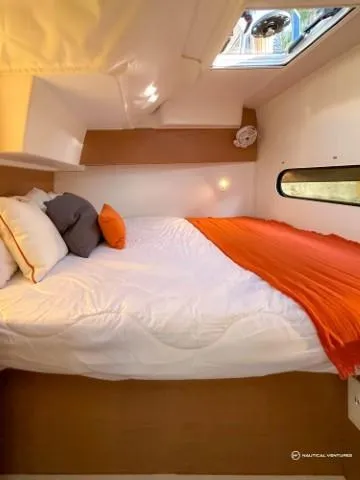 Slide: The Image of 2024 Excess 11 cabin with cozy bed, skylight, and modern decor. - 12