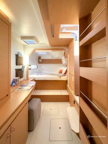 Slide: The Image of 2024 Excess 11 yacht interior with modern wood finish and cozy bedroom. - 38