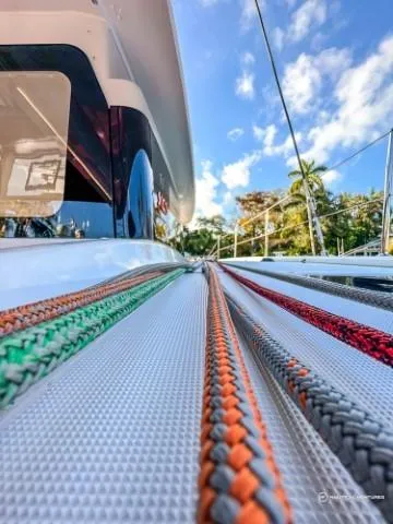 Slide: The Image of 2024 Excess 11 sailboat with colorful ropes on deck, clear sky background. - 4