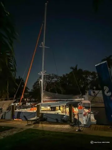 Slide: The Image of 2024 Excess 11 catamaran docked at night with illuminated interior. - 46