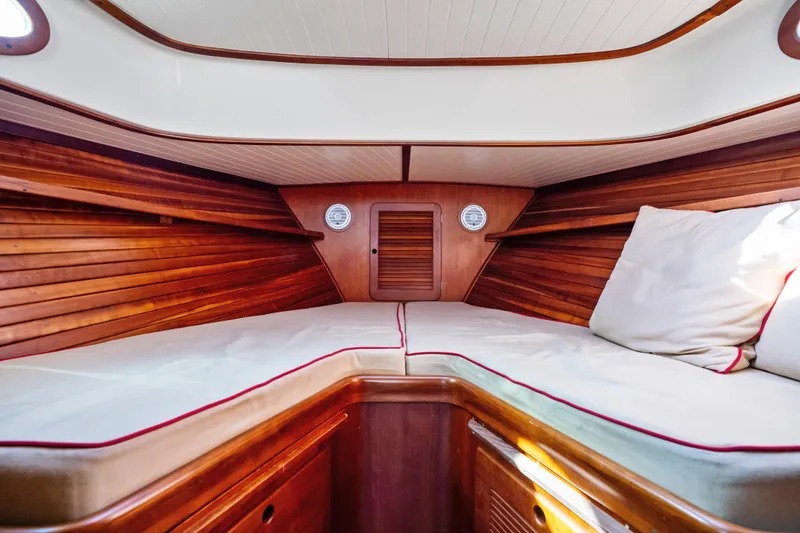 Slide: The Image of Interior of 1996 Hinckley 36 Picnic Boat Classic with wooden finish and cozy seating. - 18