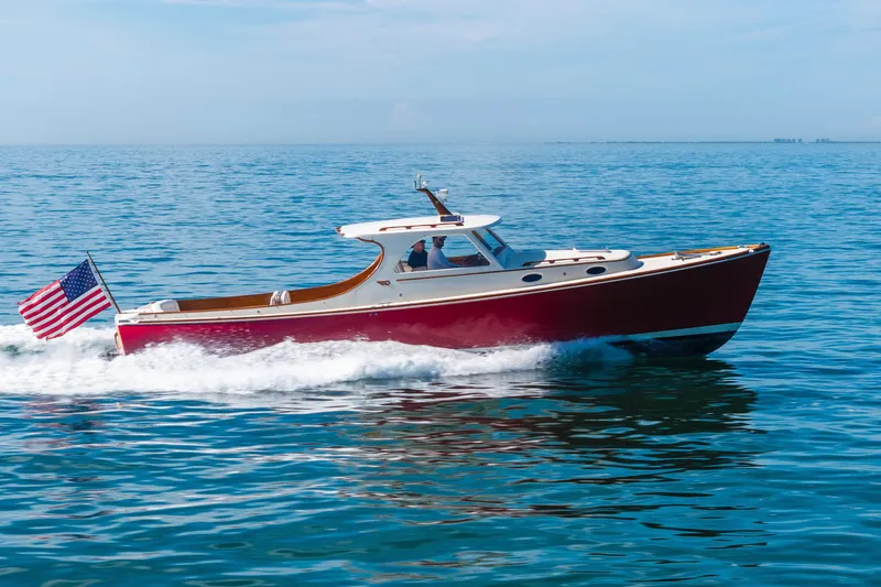 Slide: The Image of Hinckley 36 Picnic Boat Classic 1996 cruising on open water with American flag. - 6