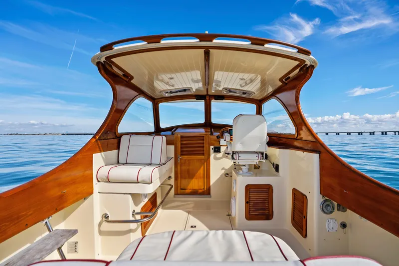 Slide: The Image of 1996 Hinckley 36 Picnic Boat Classic interior with wooden accents and ocean view. - 13