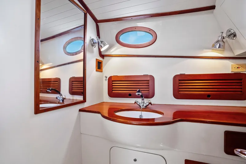 Slide: The Image of 1996 Hinckley 36 Picnic Boat Classic interior with wooden accents and modern fixtures. - 20