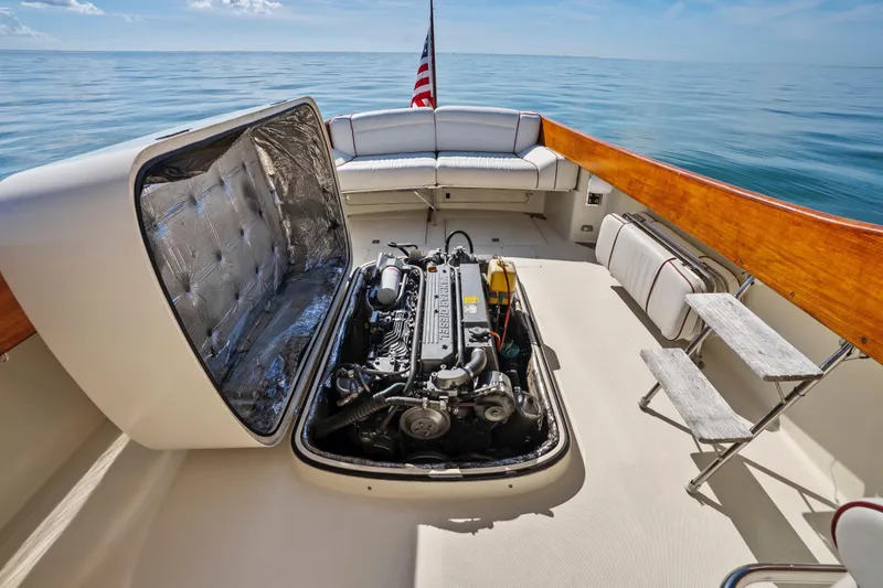 Slide: The Image of 1996 Hinckley 36 Picnic Boat Classic with open engine compartment, on calm sea. - 21