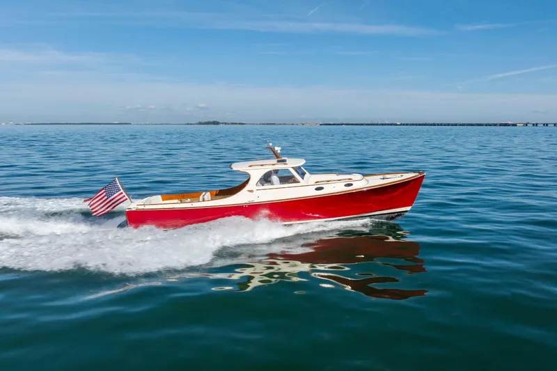 Slide: The Image of 1996 Hinckley 36 Picnic Boat Classic cruising on open water under clear skies. - 4