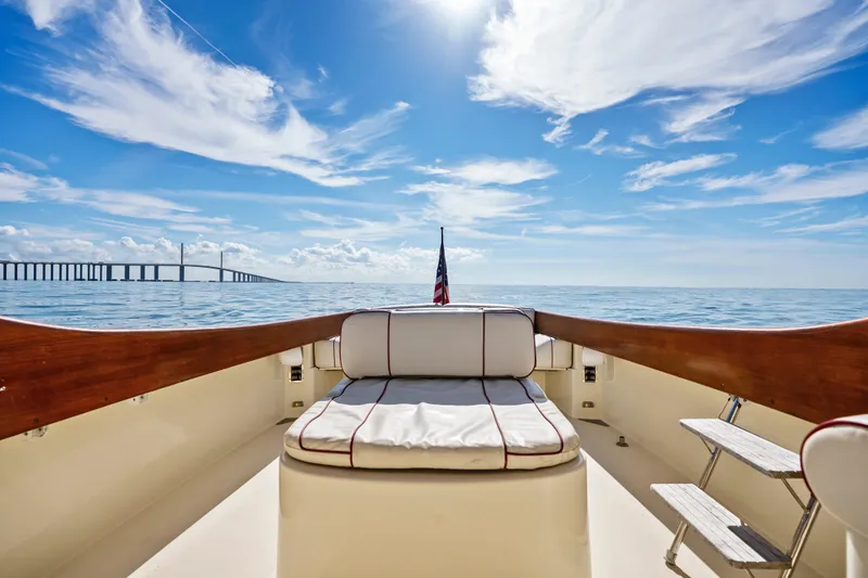 Slide: The Image of Hinckley 36 Picnic Boat Classic 1996 on serene ocean with bridge and blue sky. - 8