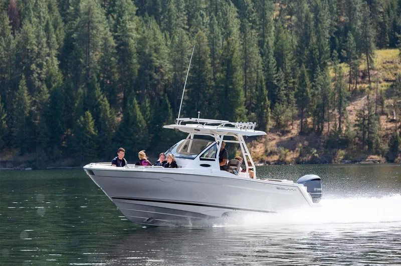 Slide: The Image of 2023 Solara S-250 CW boat cruising on a lake with passengers. - 2