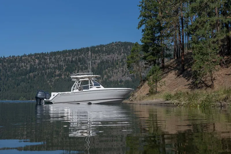 Slide: The Image of 2023 Solara S-250 CW boat docked by a forested lakeshore. - 28