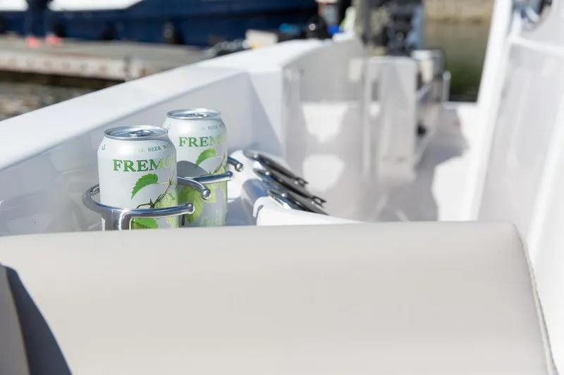 Slide: The Image of Two cans of Fremont beer in cup holders on a 2023 Solara S-250 CW boat. - 31