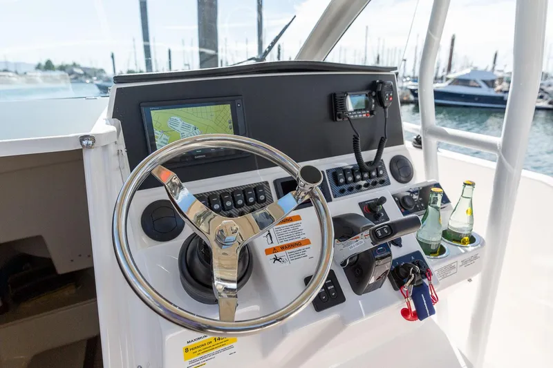 Slide: The Image of Control panel of 2023 Solara S-250 CW boat with steering wheel and navigation equipment. - 9