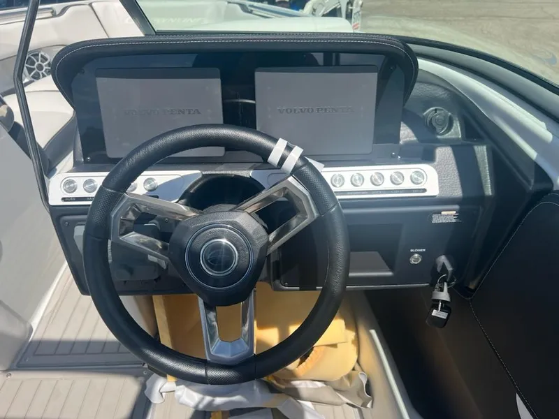 Slide: The Image of 2023 Crownline 240 SS SURF boat dashboard with dual screens and steering wheel. - 3